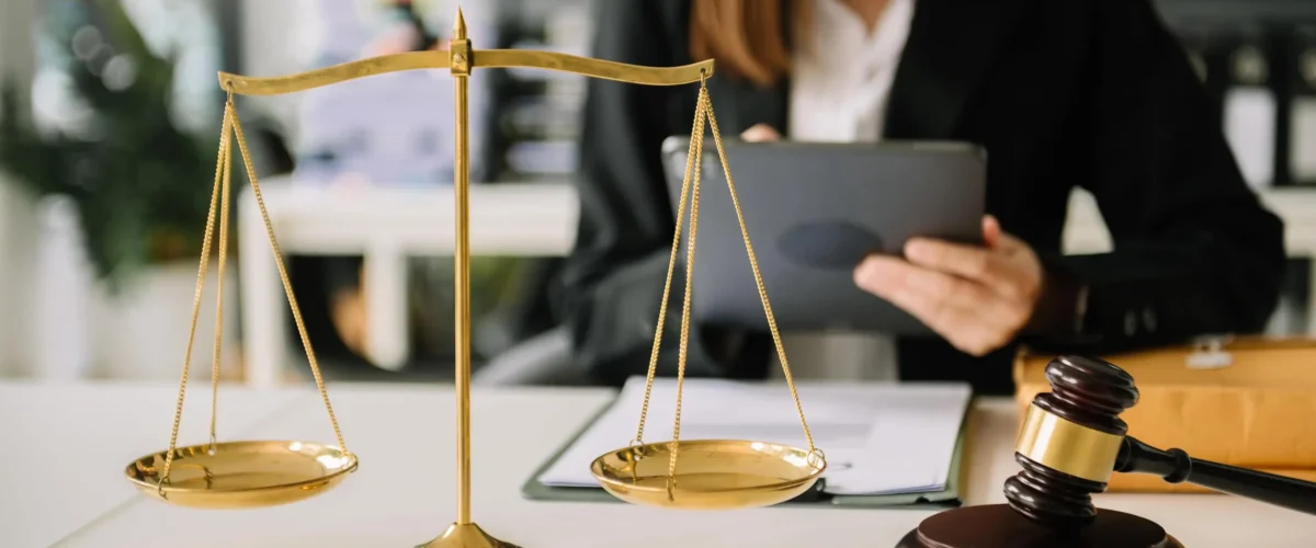 male-lawyer-in-the-office-with-brass-scale-min